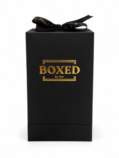 BOXED by Dee Premium gift box. Black box with Premium Gold Foil BOXED by Dee logo and premium black satin ribbon with gold foil text positioned on a white background. 