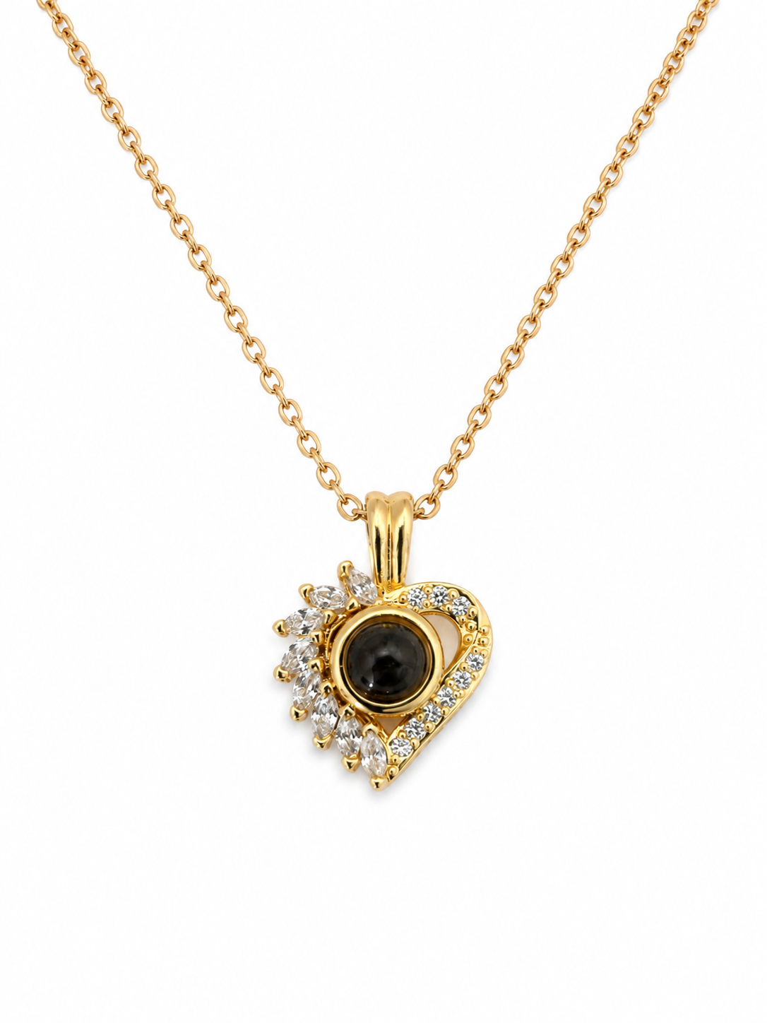 A gold heart-shaped pendant necklace / jewellery piece, featuring a central black oval stone surrounded by small clear stones, suspended from a delicate gold chain on a white background. 