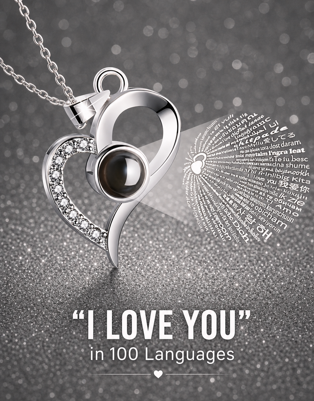 Silver heart-shaped pendant with a black gemstone on a gray background with 'I Love You' text in multiple languages.
