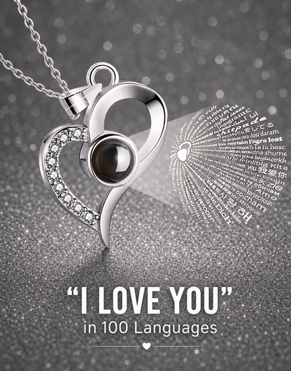 Silver heart-shaped pendant with a black gemstone on a gray background with 'I Love You' text in multiple languages.